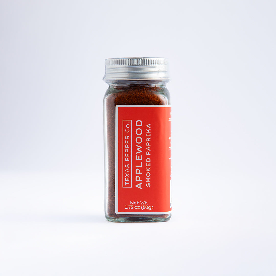 Glass jar of Texas Pepper Co. Applewood Smoked Paprika, 1.75 oz (50g), with red label and metal lid, filled with deep red paprika powder