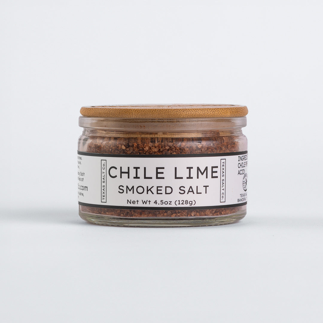 Glass jar of Texas Salt Co. Chile Lime Smoked Salt, 4.5 oz (128g), with bamboo lid and white label.