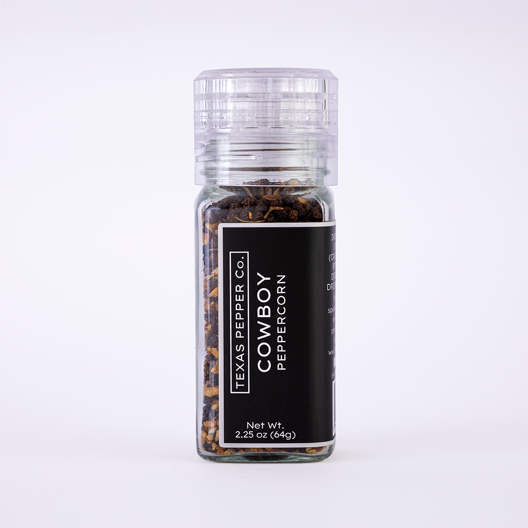 Glass grinder jar of Texas Pepper Co. Cowboy Peppercorn, 2.25 oz (64g), with black label, filled with smoked peppercorn blend.