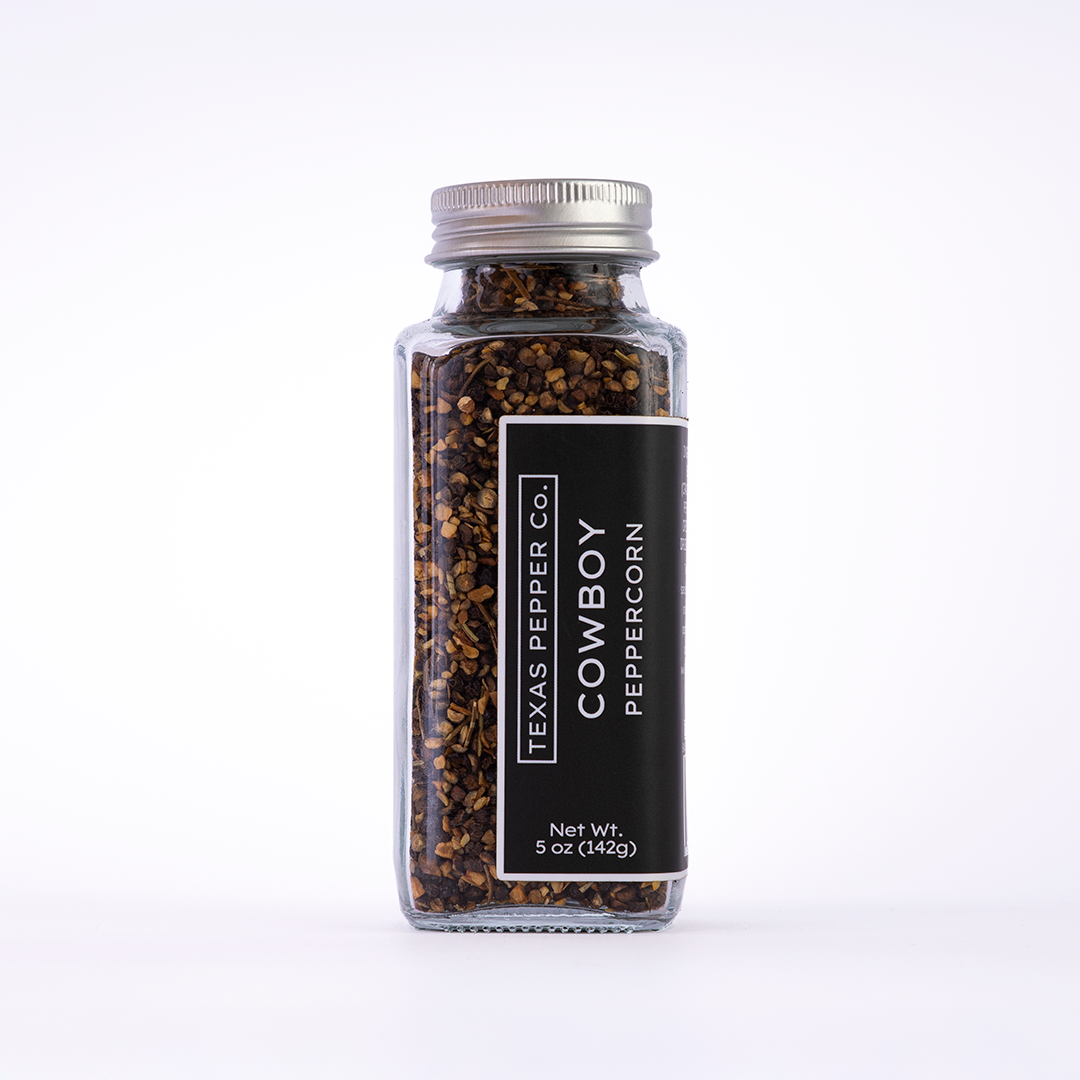 Glass jar of Texas Pepper Co. Cowboy Peppercorn, 5 oz (142g), with black label, filled with coarse smoked peppercorn blend.