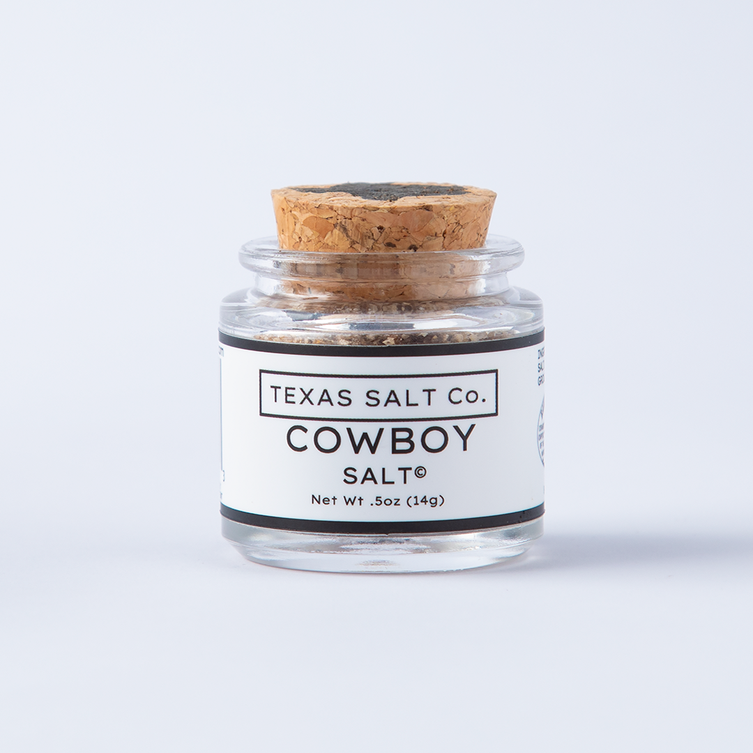 Front view of Texas Salt Co.’s Cowboy Salt in a 0.5 oz glass jar with cork lid on white background.