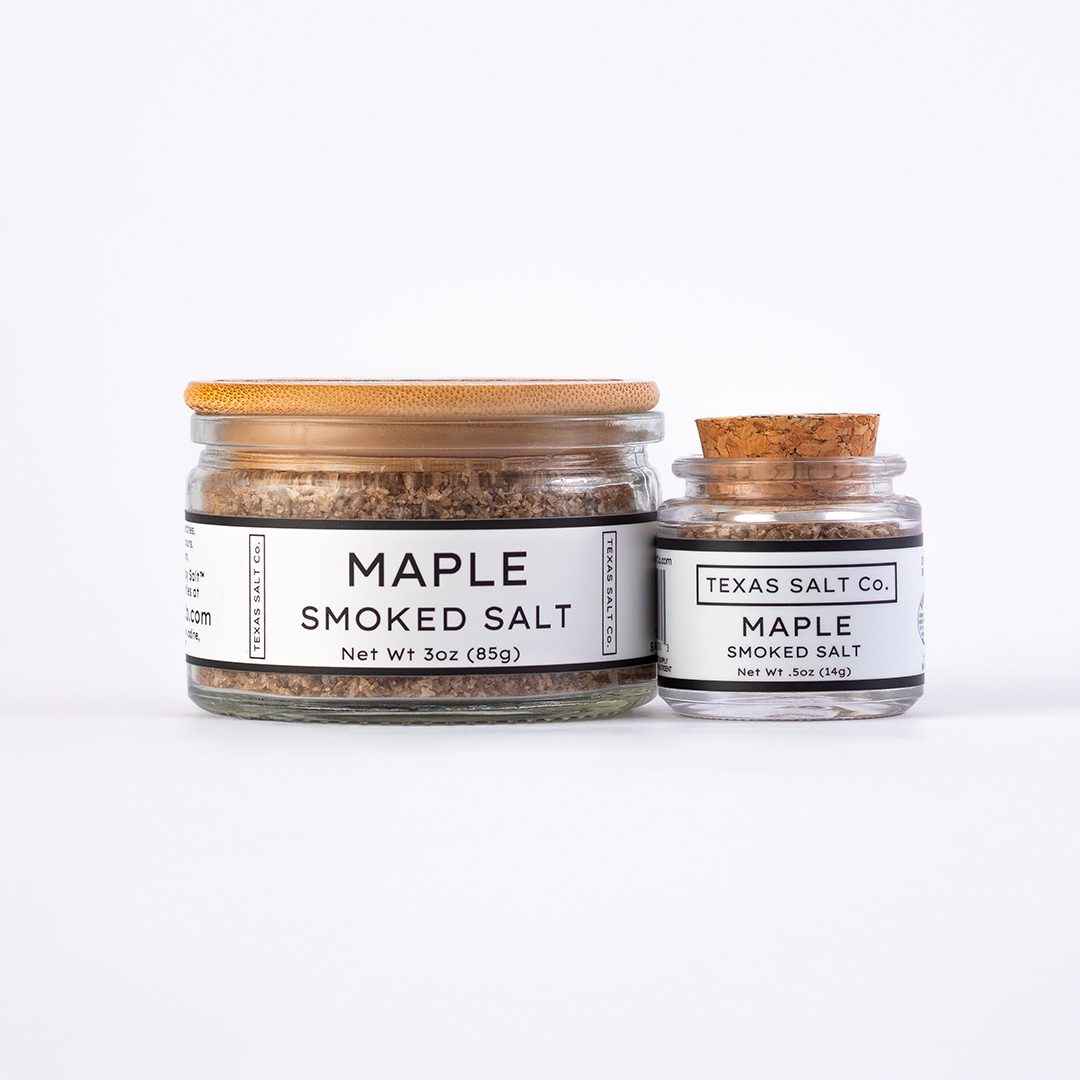 Texas Salt Co. Maple Smoked Salt in 3oz bamboo-lid jar and .5oz cork-top jar displayed side by side on a white background.