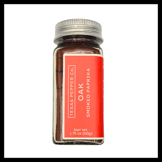 Texas Salt Co. Oak Smoked Paprika – cork-top and bamboo-lid glass jars filled with deep red pecan wood–smoked paprika, offering a bold, slightly sweet heat perfect for meats, stews, and rubs