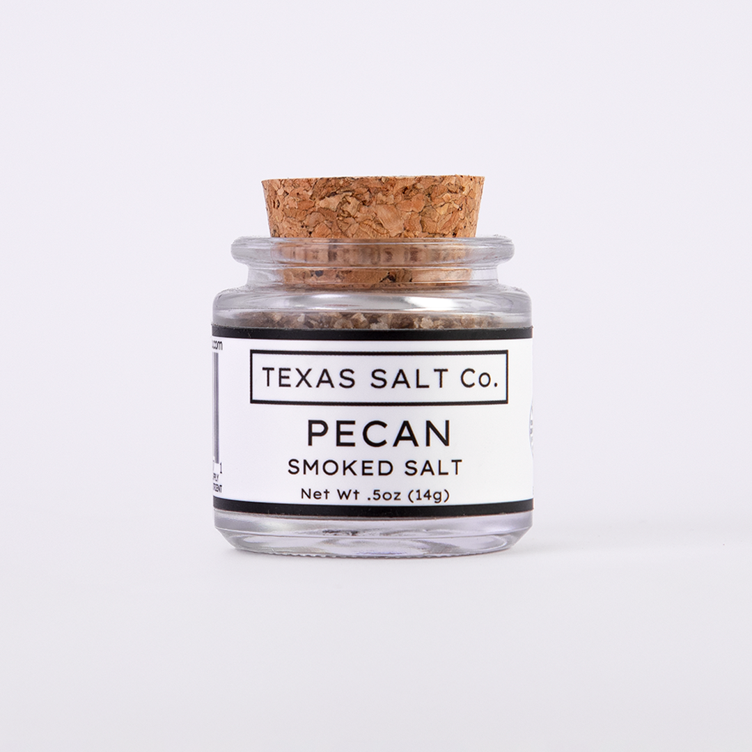 Mini glass jar of Texas Salt Co. Pecan Smoked Salt, 0.5 oz (14g), with cork lid and white label, filled with small-batch smoked salt.