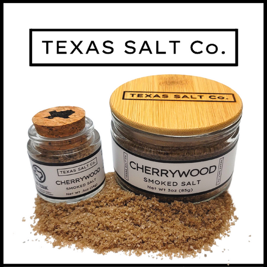 Texas Salt Co. Cherrywood Smoked Salt – cork-top and bamboo-lid jars filled with cherrywood-smoked sea salt, offering a mild, sweet smoke flavor ideal for pork, chicken, and everyday cooking