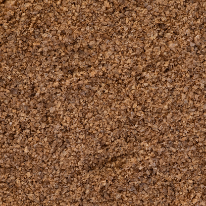 Close-up texture shot of Texas Salt Co. Applewood Smoked Salt showing coarse grains and natural applewood-smoke color.