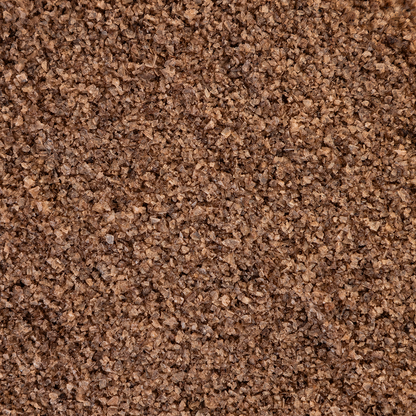 Close-up texture shot of Texas Salt Co. Charcoal Smoked Salt showing coarse grains and natural charcoal-smoke color.
