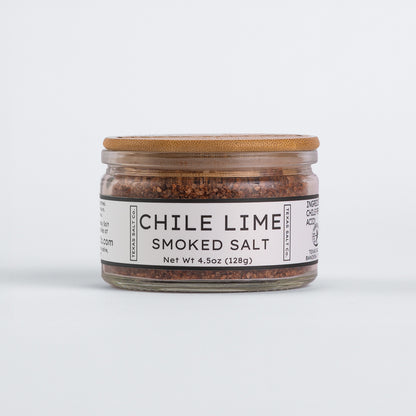 Glass jar of Texas Salt Co. Chile Lime Smoked Salt, 4.5 oz (128g), with bamboo lid and white label.