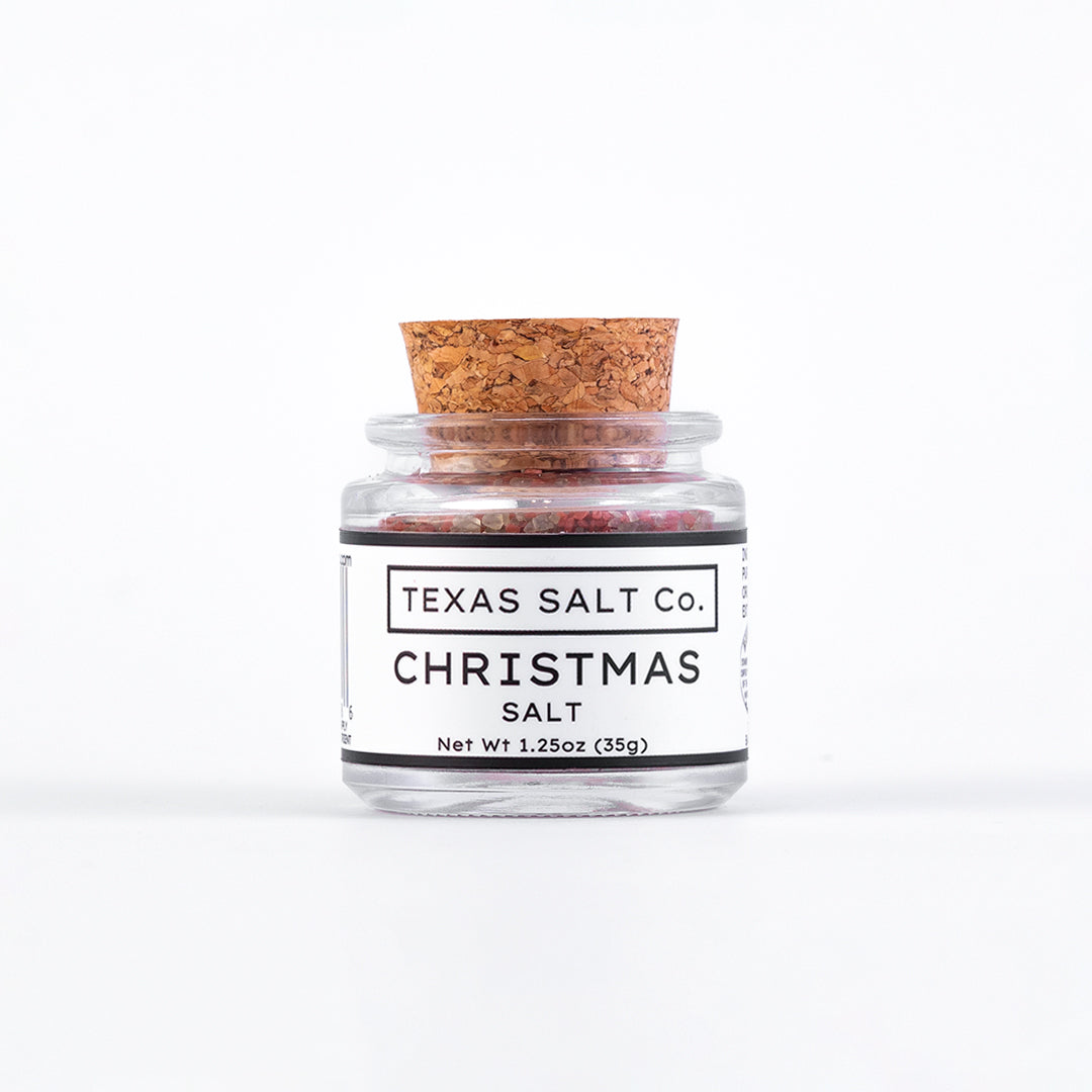 Jar of Texas Salt Co. Christmas salt with a cork lid on a white background