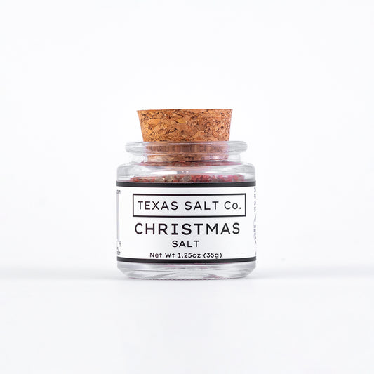 Jar of Texas Salt Co. Christmas salt with a cork lid on a white background