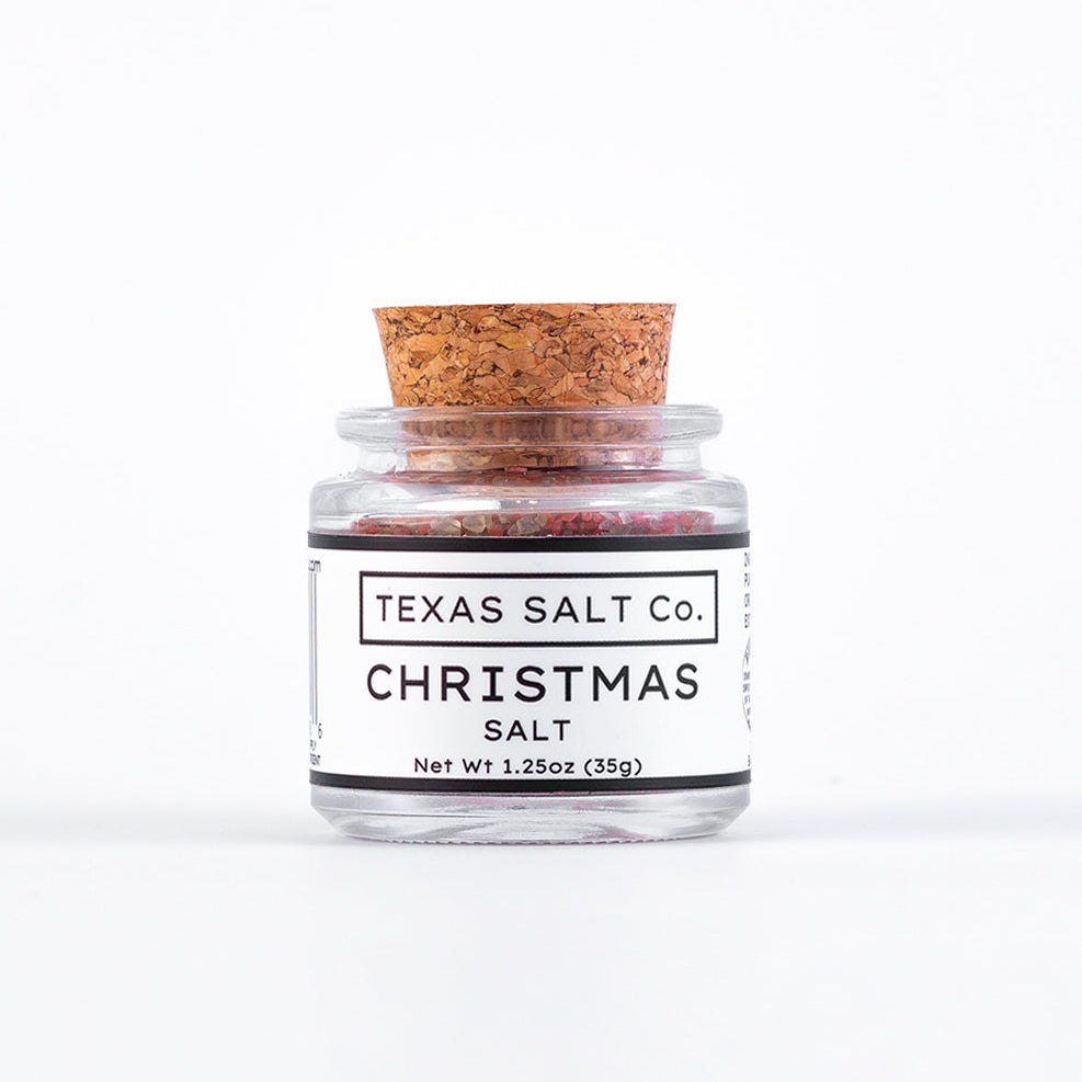 Jar of Texas Salt Co. Christmas salt with a cork lid on a white background
