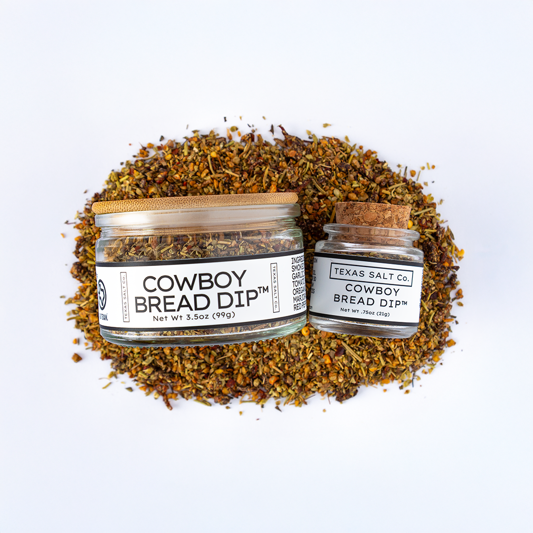 Cowboy Bread Dip™ 3.5oz and .75oz jars on a bed of blended herbs and spices