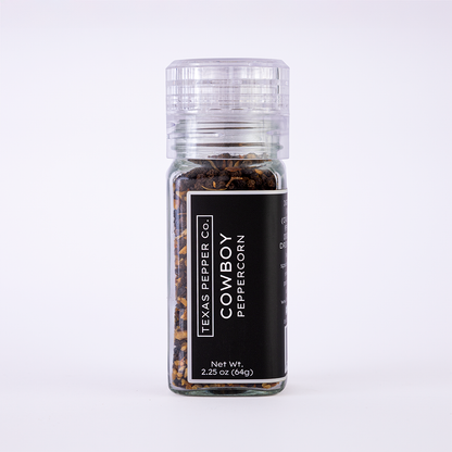 Glass grinder jar of Texas Pepper Co. Cowboy Peppercorn, 2.25 oz (64g), with black label, filled with smoked peppercorn blend.