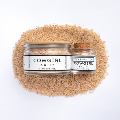 Texas Salt Co. Cowgirl Salt 3oz and 0.5oz jars on salt pile over white background