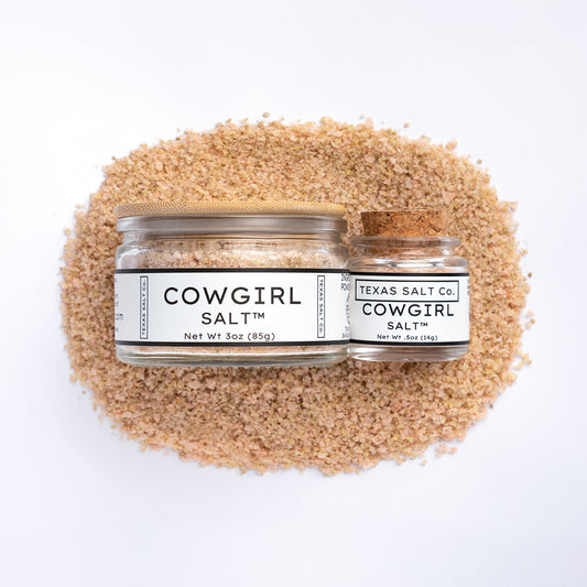 Texas Salt Co. Cowgirl Salt 3oz and 0.5oz jars on salt pile over white background
