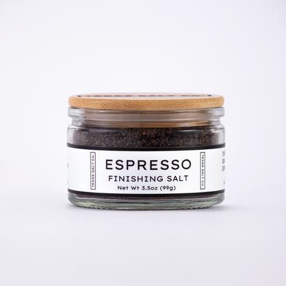 Glass jar of Texas Salt Co. Espresso Finishing Salt, 3.5 oz (99g), with bamboo lid and white label, filled with dark espresso salt.