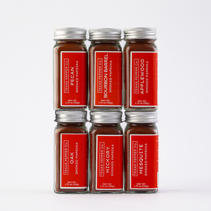 Set of six Texas Pepper Co. smoked paprika jars on a white background