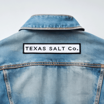 Texas Salt Co. embroidered iron-on patch applied to the back of a light blue denim jacket