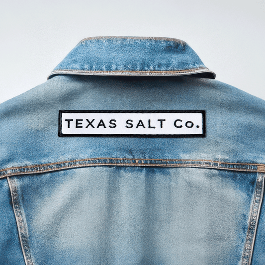 Texas Salt Co. embroidered iron-on patch applied to the back of a light blue denim jacket