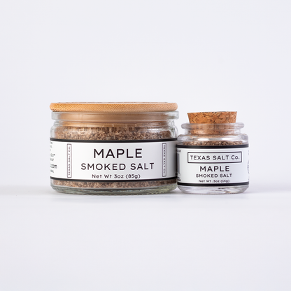 Texas Salt Co. Maple Smoked Salt in 3oz bamboo-lid jar and .5oz cork-top jar displayed side by side on a white background.