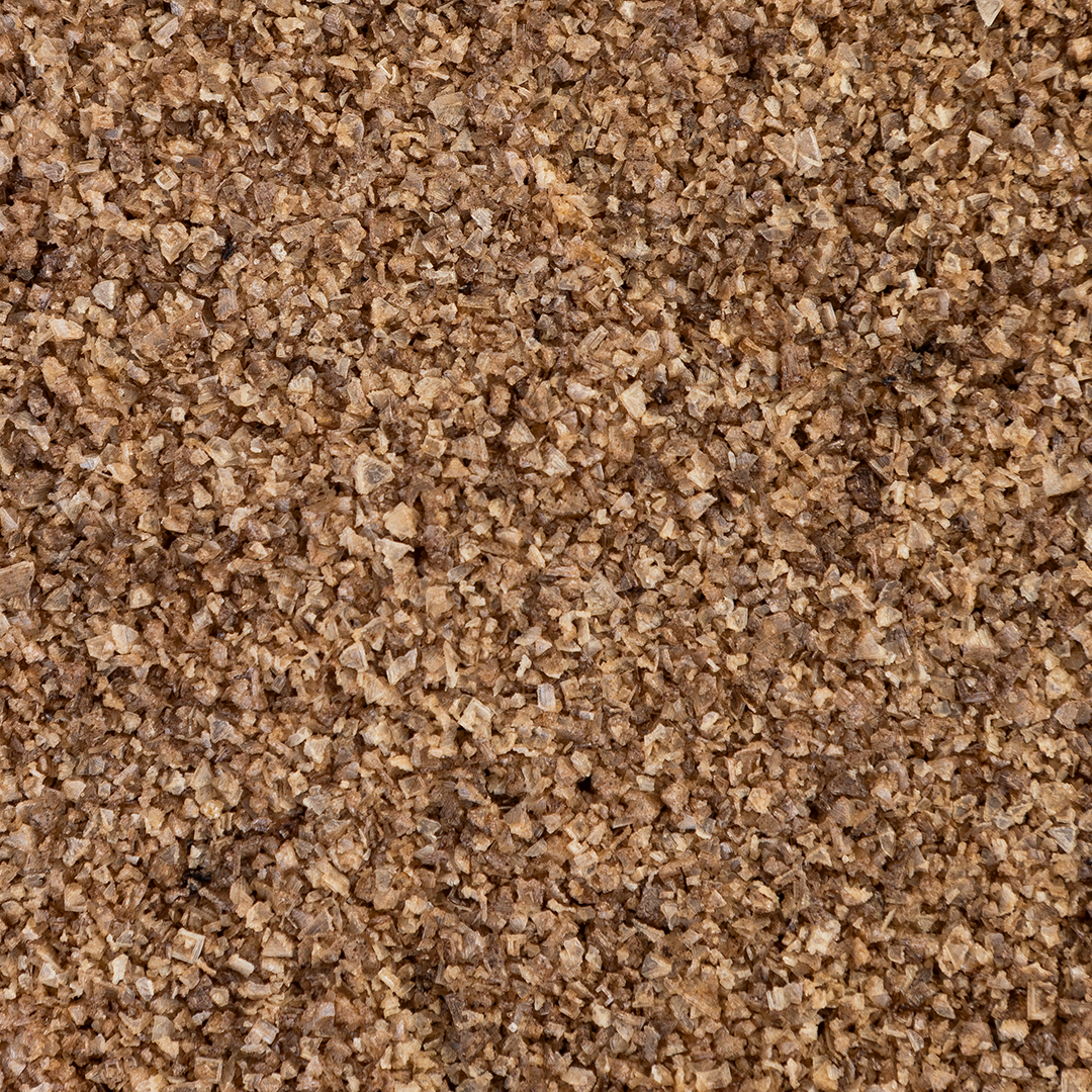 Close-up texture shot of Texas Salt Co. Maple Smoked Salt showing coarse grains and natural charcoal-smoke color.