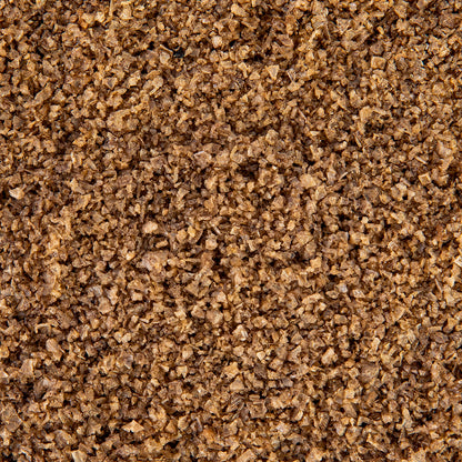 Macro close-up of Texas Salt Co. Peachwood Smoked Salt showing smoky flake texture.