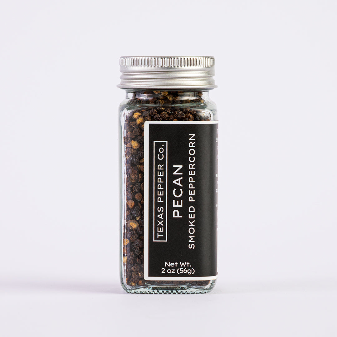2 oz glass jar of Texas Pepper Co. Pecan Smoked peppercorn on a white background
