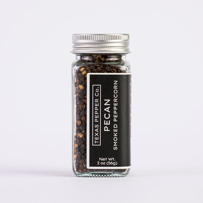 2 oz glass jar of Texas Pepper Co. Pecan Smoked peppercorn on a white background
