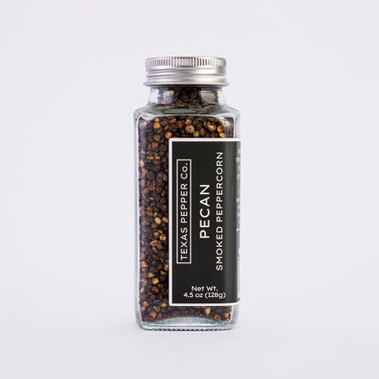 4.5 oz glass bottle of Texas Pepper Co. Pecan Smoked Peppercorn on a white background