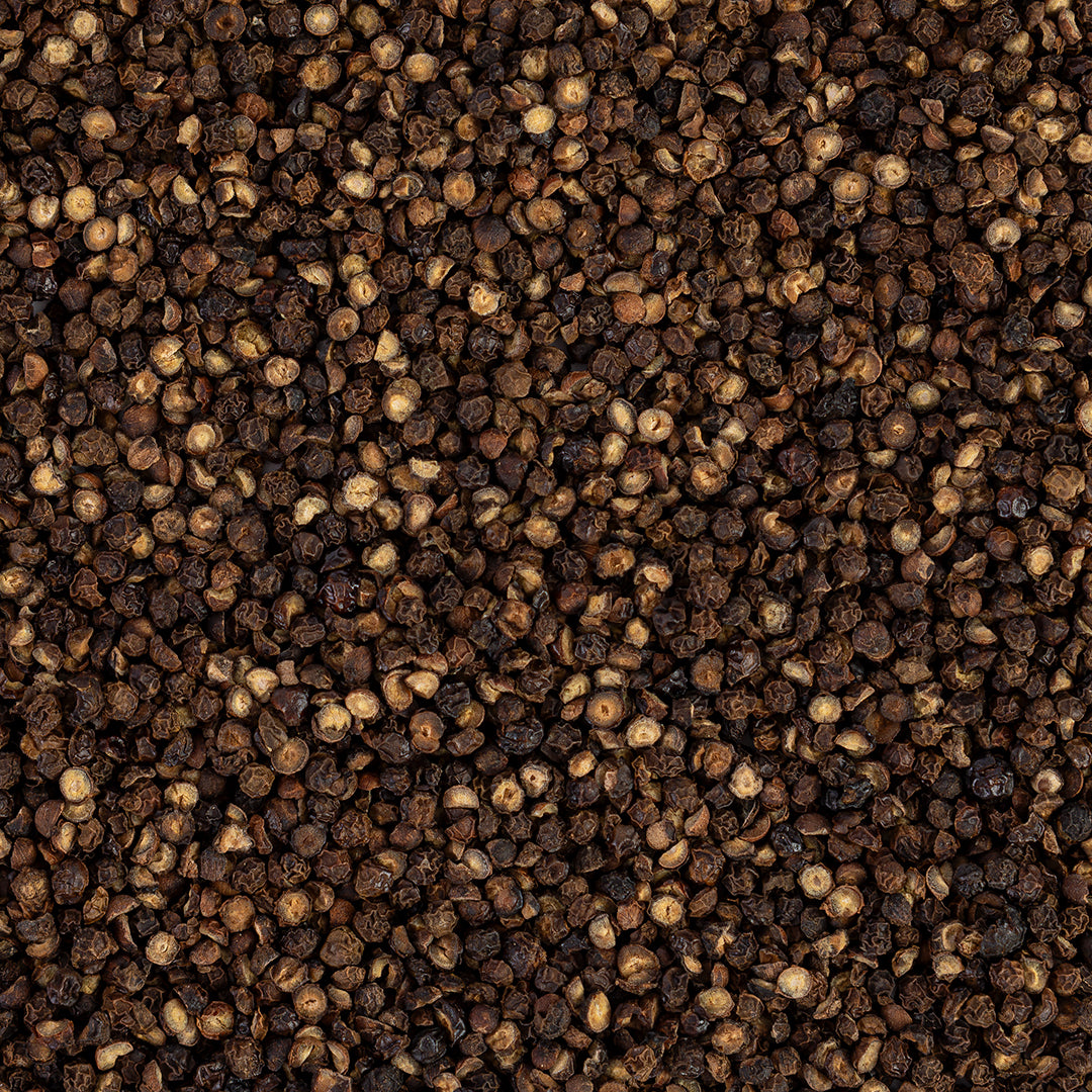 Close-up view of pecan smoked peppercorn with a dark brown color.