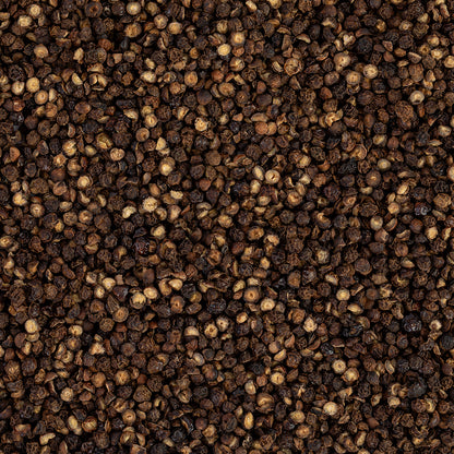 Close-up view of pecan smoked peppercorn with a dark brown color.