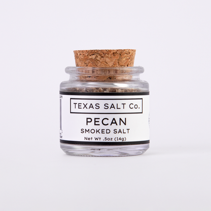 Mini glass jar of Texas Salt Co. Pecan Smoked Salt, 0.5 oz (14g), with cork lid and white label, filled with small-batch smoked salt.