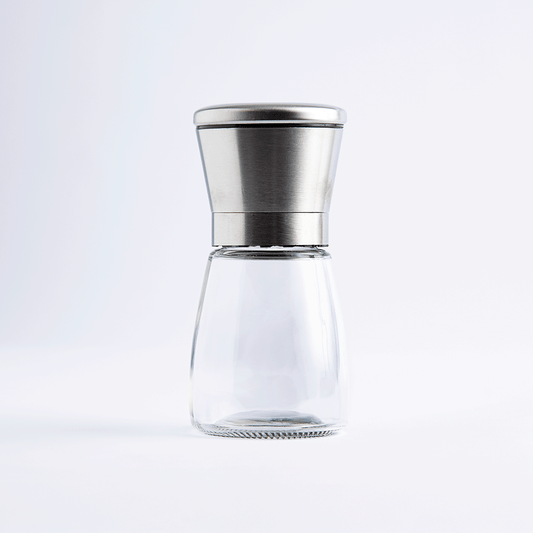 Short glass salt and pepper mill with stainless steel top, empty, on white background