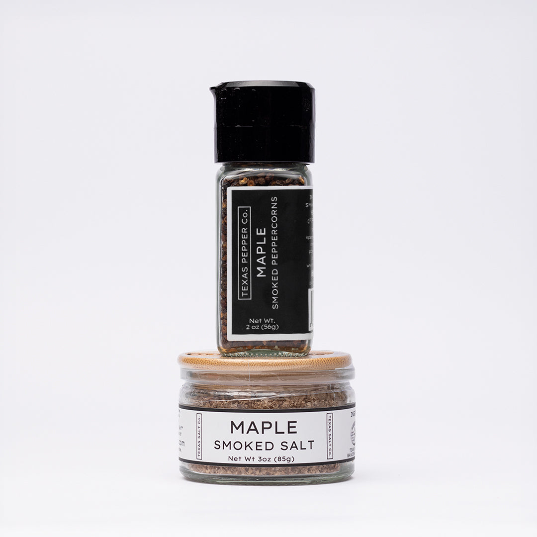 Stacked duo of Texas Salt Co. jars: grinder-top Maple Smoked Peppercorn and wide bamboo-lid Maple Smoked Salt
