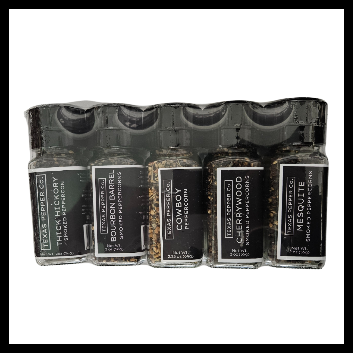Texas Salt Co. Smoked Peppercorn Gift Set – five smoked peppercorn varieties in grinder-top jars: Thick Hickory, Bourbon Barrel, Cowboy, Cherrywood, and Mesquite